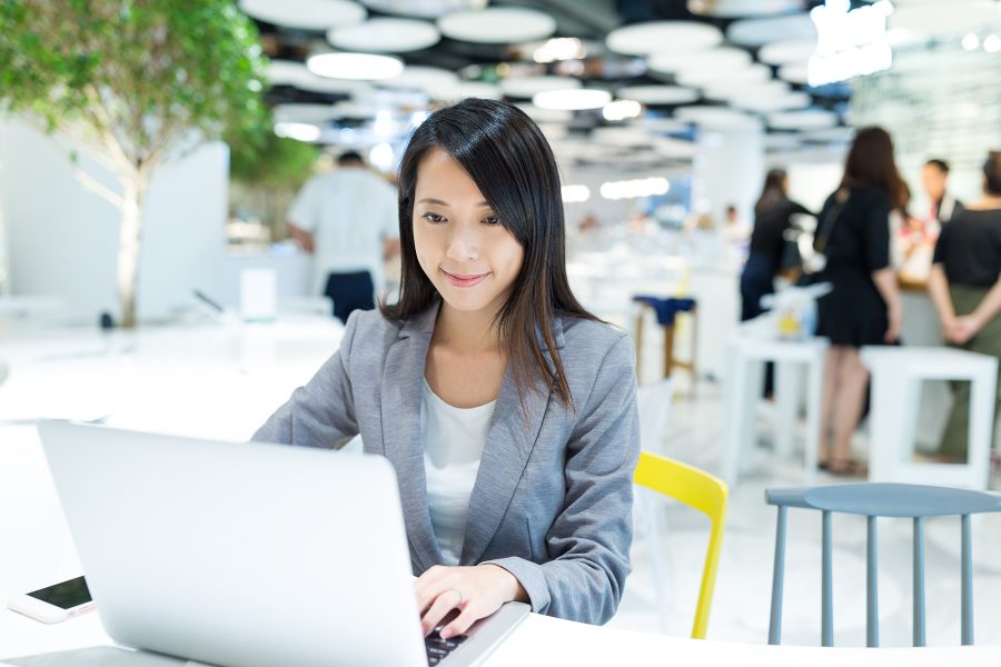 Businesswoman working on notebook computer at co work space